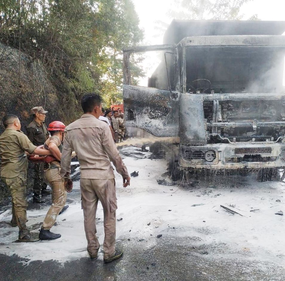 Police examining the remains of the truck destroyed by the fire in Tuli on January 7.